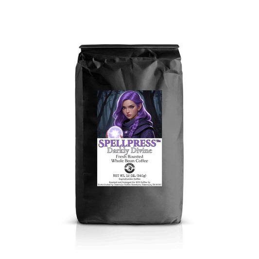 A black 12 oz coffee bag labeled “Spellpress™ – Darkly Divine” featuring the same purple-haired witch character. Labeled “Fresh Roasted Whole Bean Coffee.”